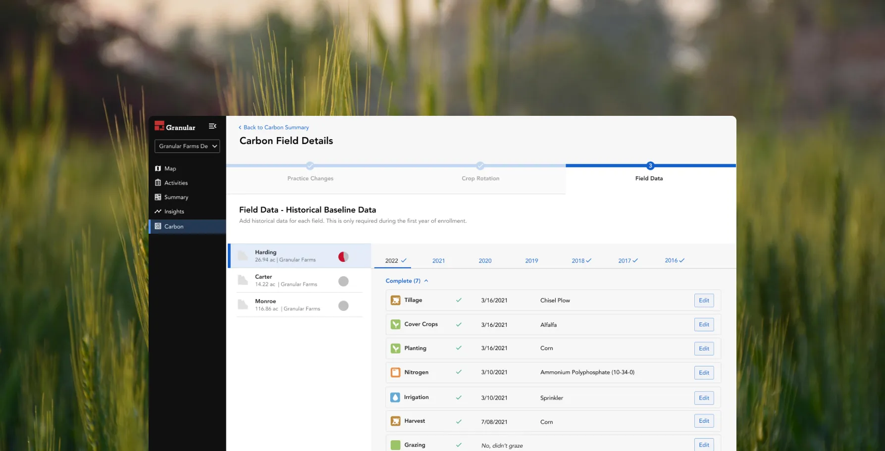 Granular Insights carbon field details screen showing historical baseline data for a field, over a photograph of a crop field